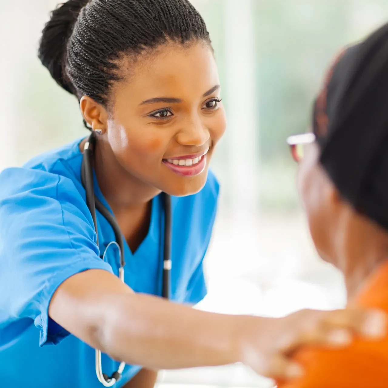 stock-photo-caring-african-medical-nurse-comforting-senior-patient-in-office-151335629-1920w