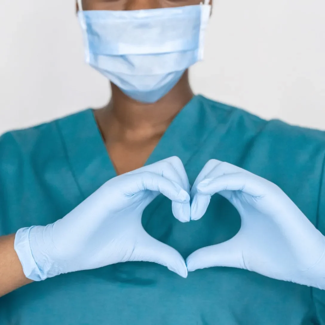 stock-photo-female-african-professional-medic-nurse-wear-face-mask-gloves-blue-green-uniform-showing-heart-1761627956-1920w